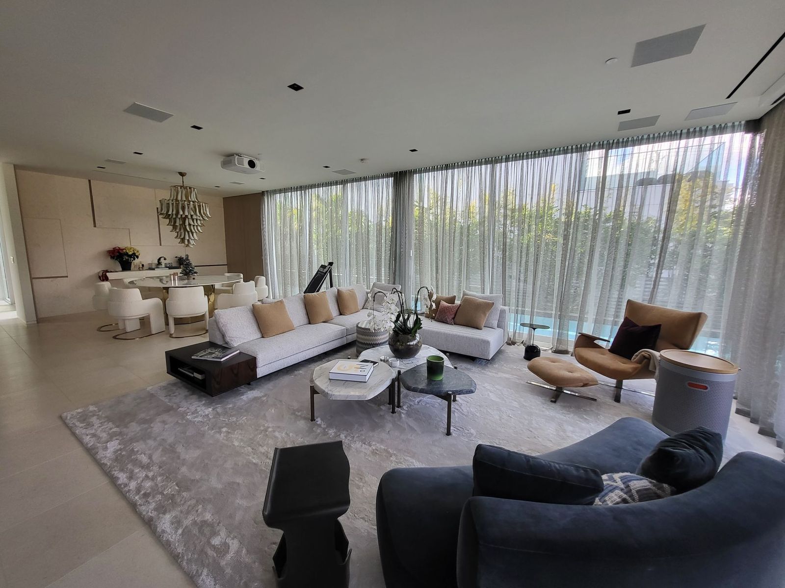 Waterfront living room at the Ritz-Carlton Residences Miami Beach with ripplefold sheers on Lutron Sivoia QS motorized tracks
